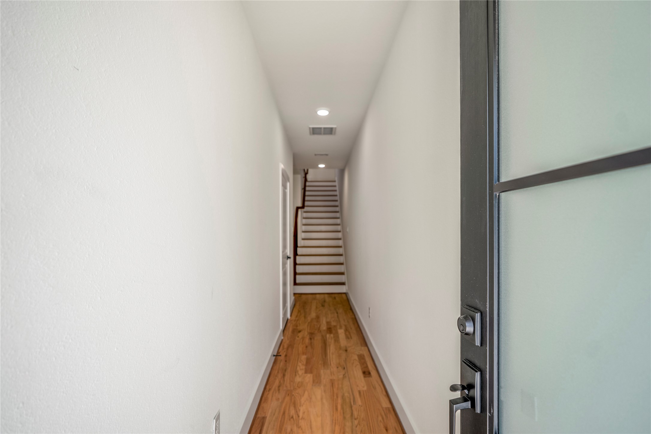 6324 Del Rio Street Houston, TX 77021 - Photo 3 of 50 a view of a hallway with wooden floor and stairs