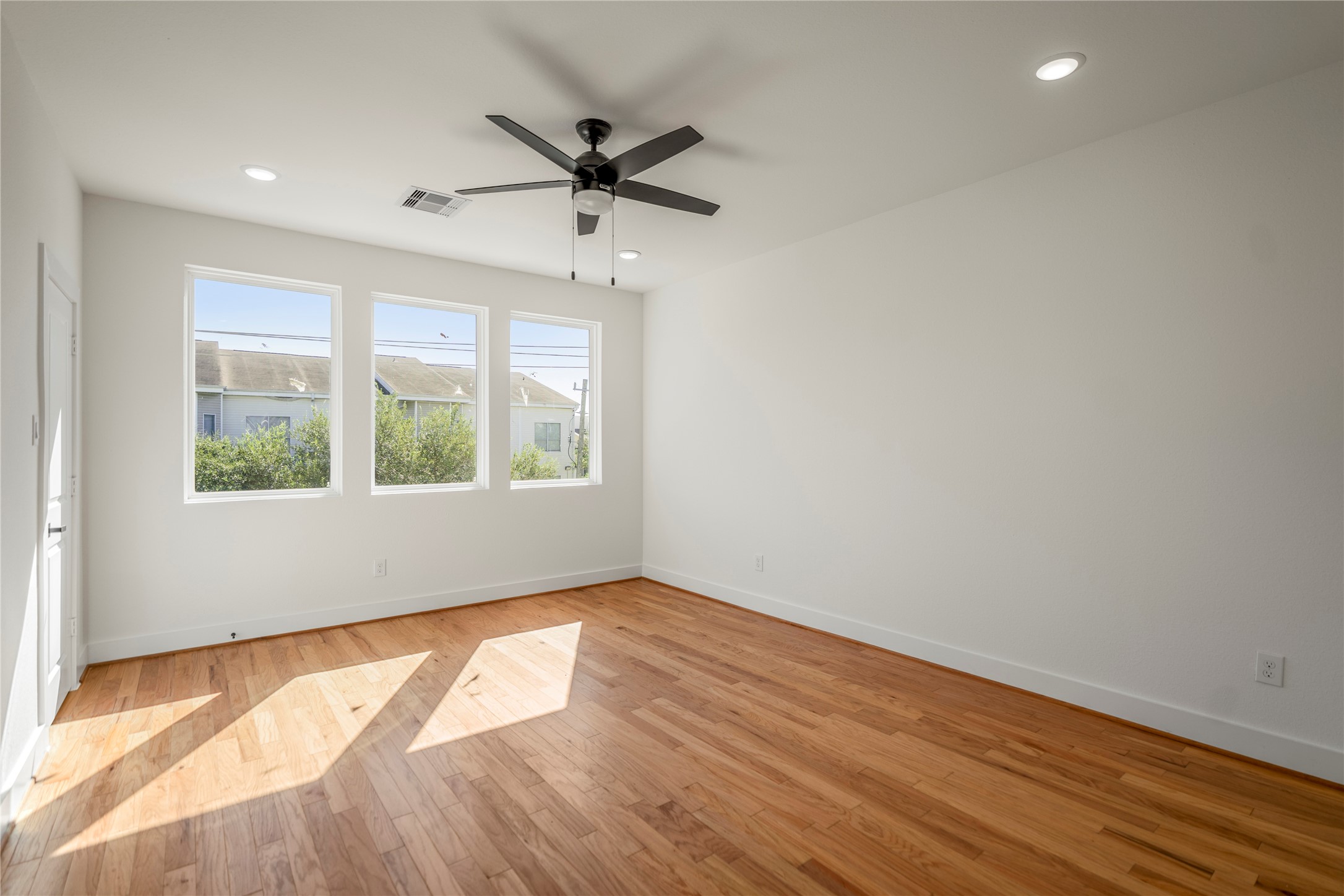 6324 Del Rio Street Houston, TX 77021 - Photo 35 of 50 an empty room with wooden floor fan and windows