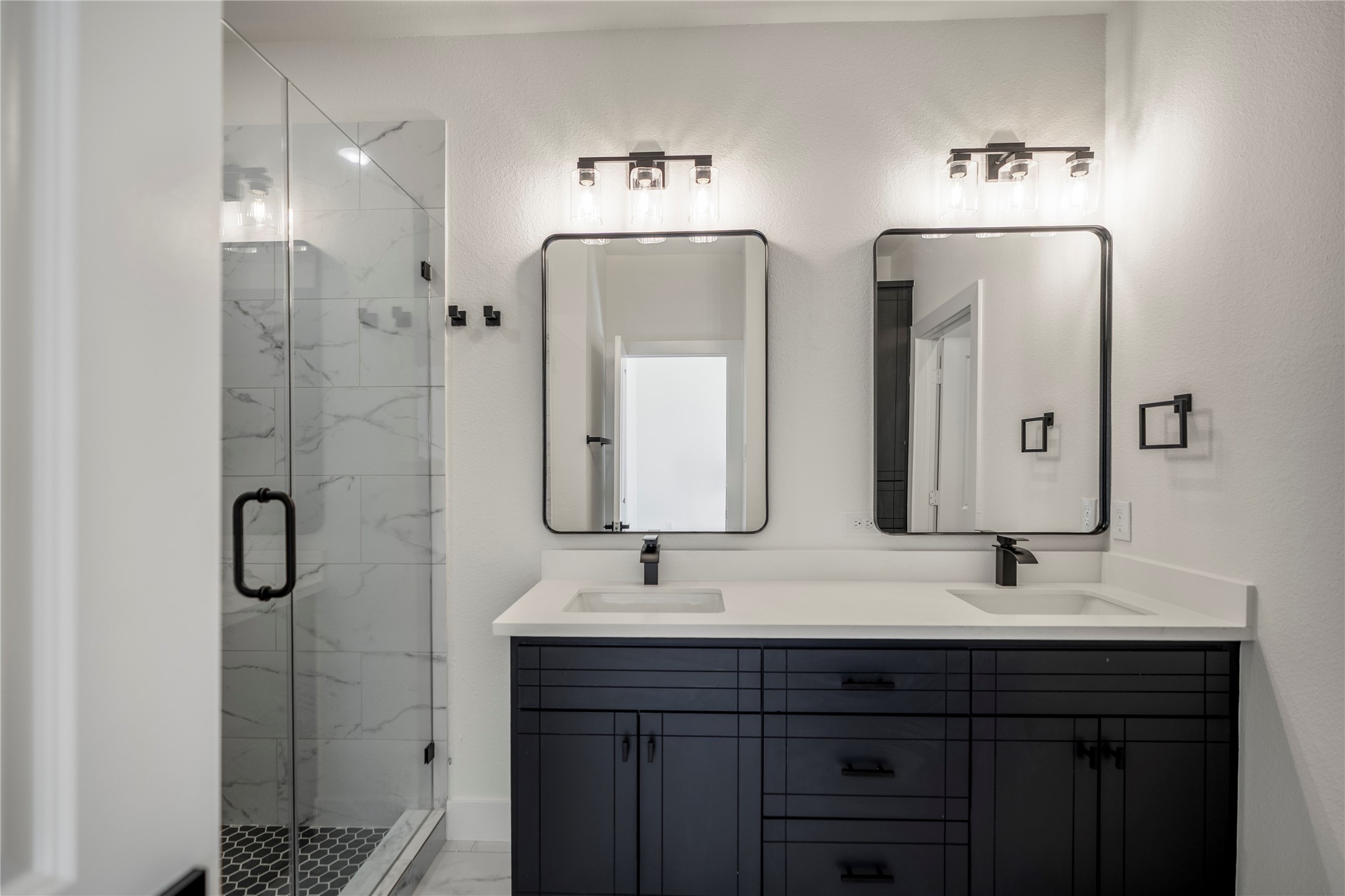 6324 Del Rio Street Houston, TX 77021 - Photo 37 of 50 a bathroom with double vanity sinks and a mirror