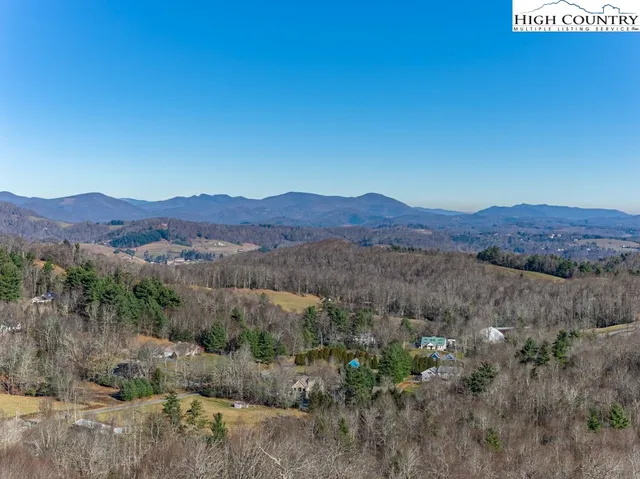 a view of a lush green hillside and houses