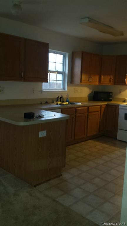 640 Cliffs Inn Circle Charlotte, NC 28214 - Photo 5 of 11 a kitchen with stainless steel appliances granite countertop a stove a sink and a microwave