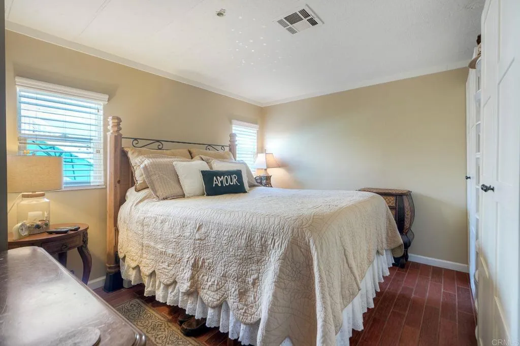 6550 Ponto, Unit 78 Carlsbad, CA 92011 - Photo 17 of 33 a bedroom with a bed and a window