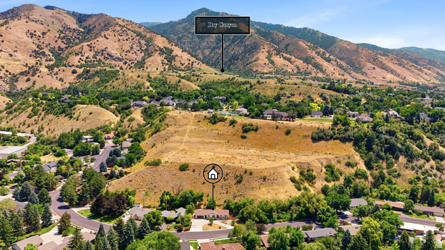 1410 Sumac Drive Logan, UT 84321 - Photo 28 of 28 Aerial perspective showcasing a single-story residence with a light-toned exterior, dark roof, and an attached garage