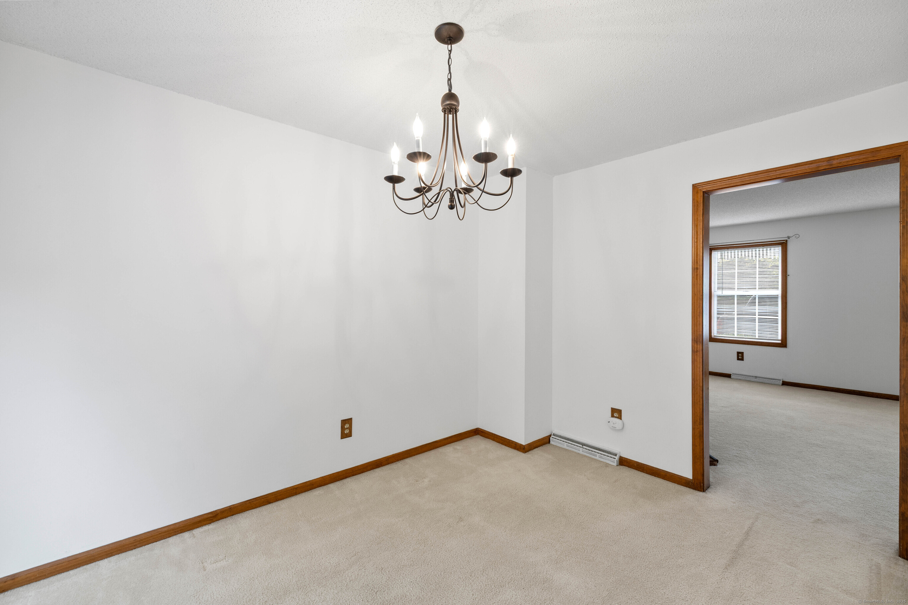 226 Austin Ryer Lane, Unit 226 Branford, CT 06405 - Photo 12 of 34 a view of a room with cabinet and chandelier