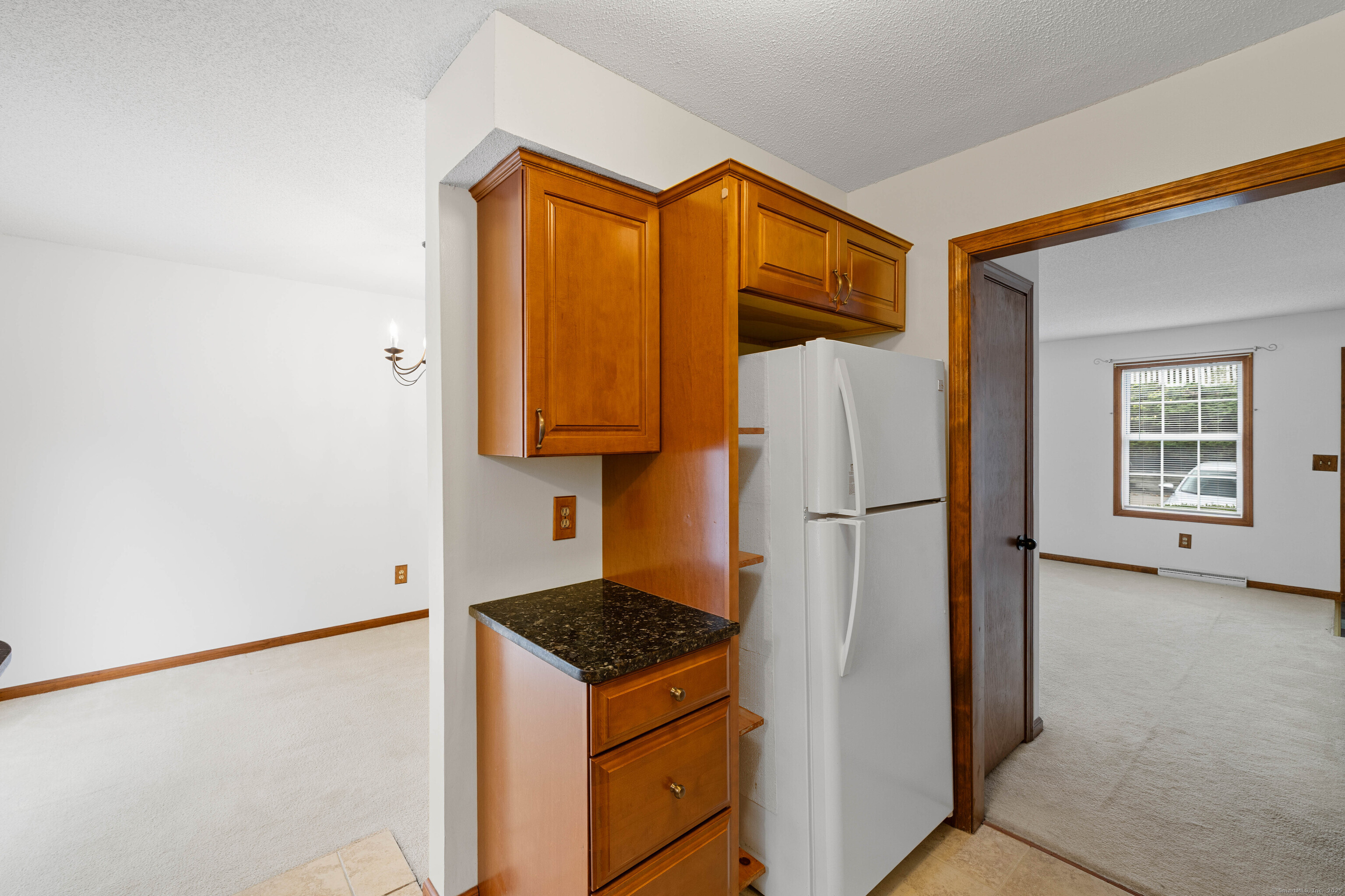 226 Austin Ryer Lane, Unit 226 Branford, CT 06405 - Photo 16 of 34 a view of a kitchen with a refrigerator and a cabinets