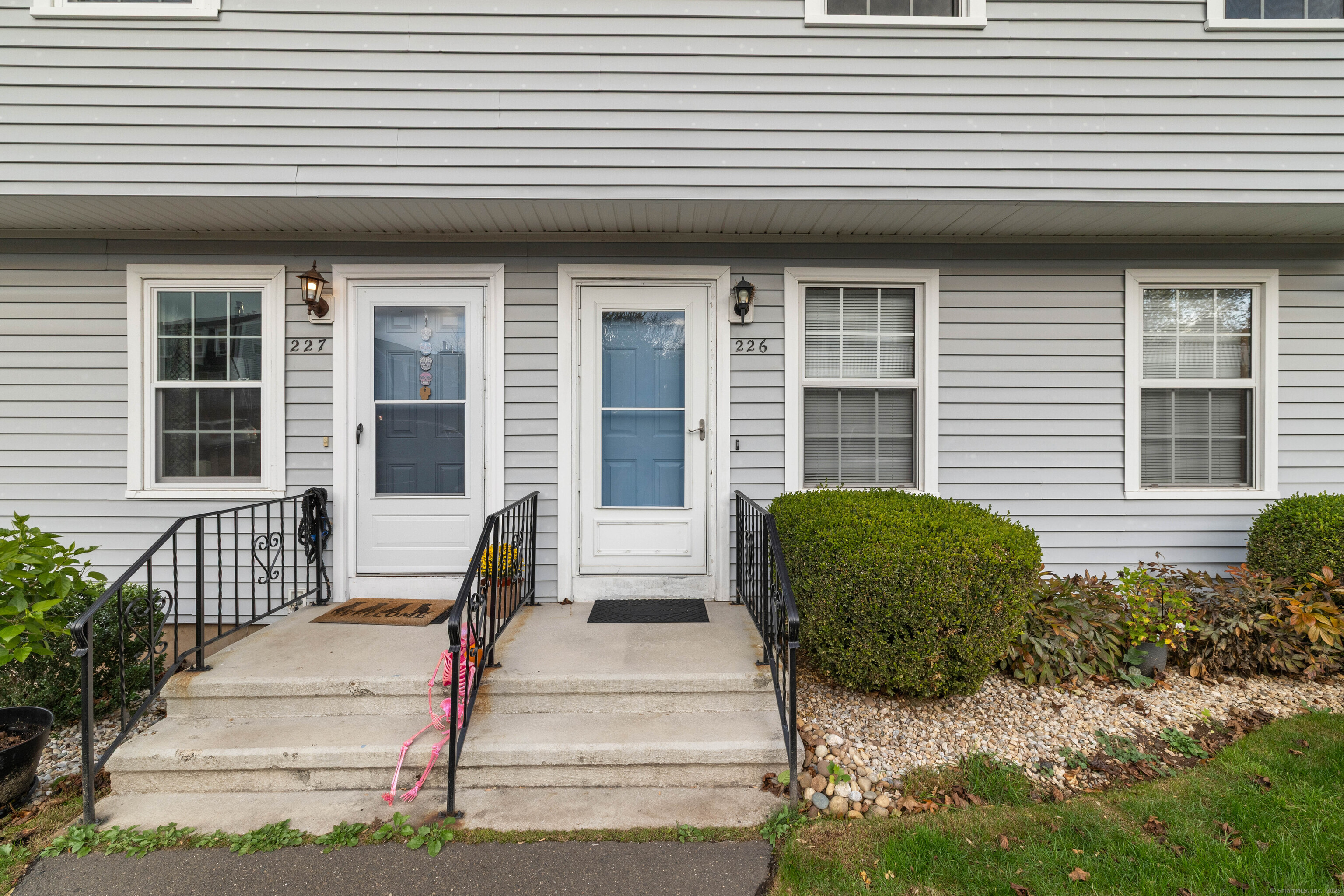 226 Austin Ryer Lane, Unit 226 Branford, CT 06405 - Photo 2 of 34 a front view of a house with a garden
