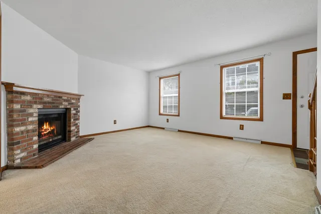 a view of an empty room with a fireplace