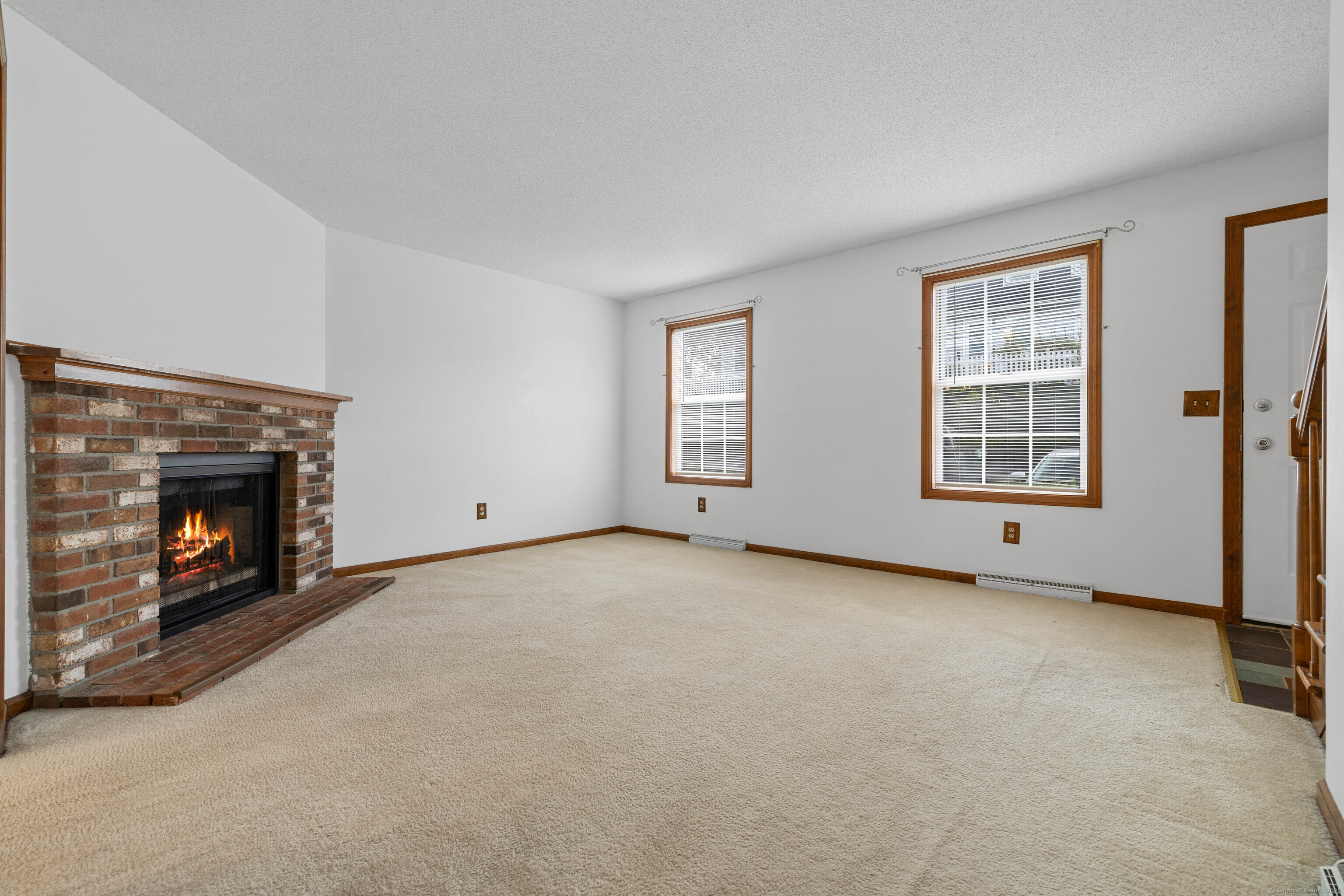 226 Austin Ryer Lane, Unit 226 Branford, CT 06405 - Photo 3 of 34 a view of an empty room with a fireplace