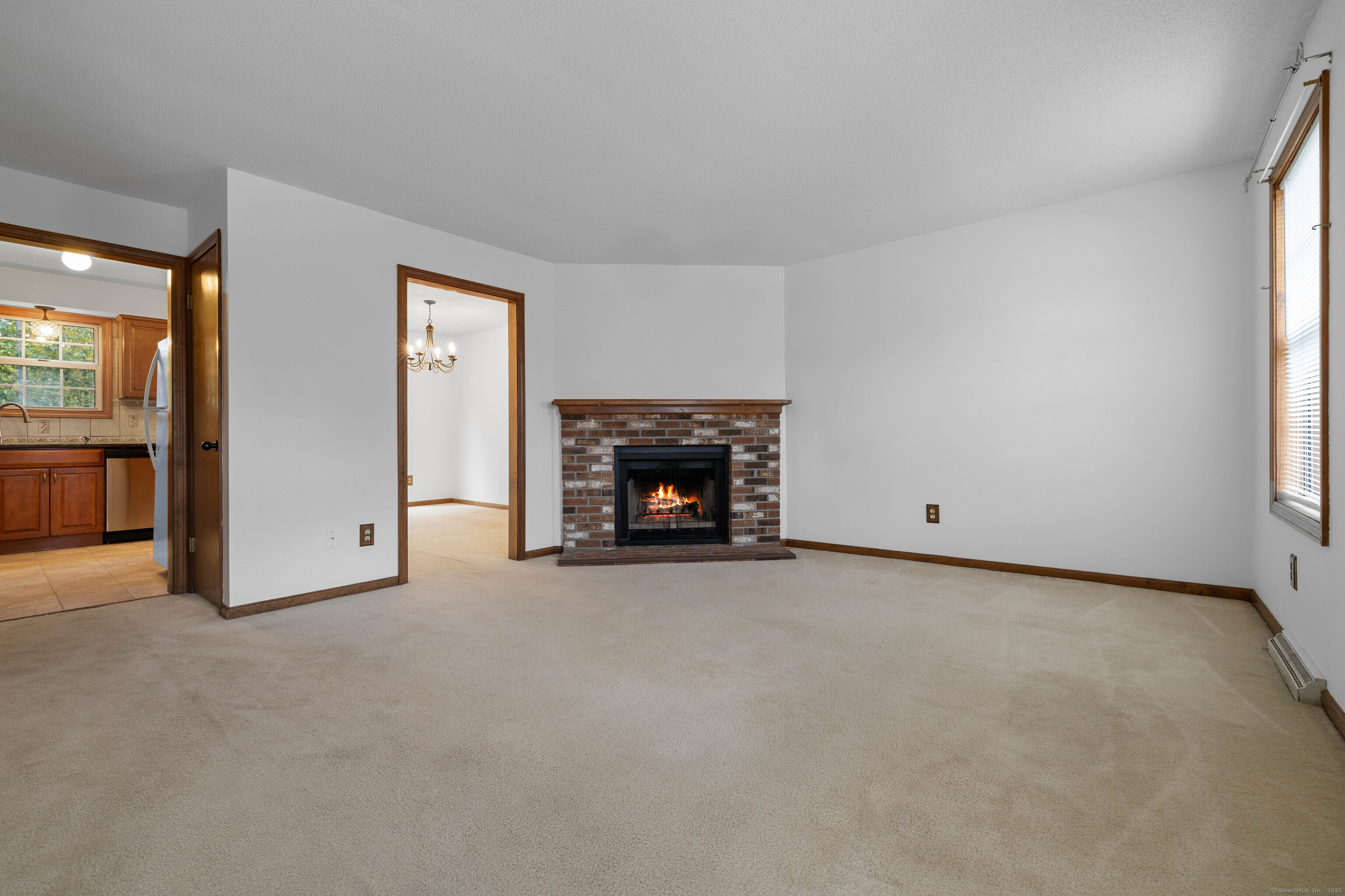 226 Austin Ryer Lane, Unit 226 Branford, CT 06405 - Photo 10 of 34 an empty room with fireplace