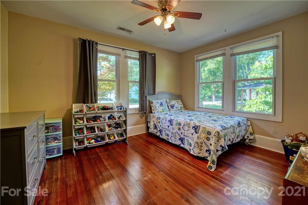 36 Bluff Avenue Southwest Concord, NC 28027 - Photo 11 of 18 a bedroom with a bed closet and flat tv screen