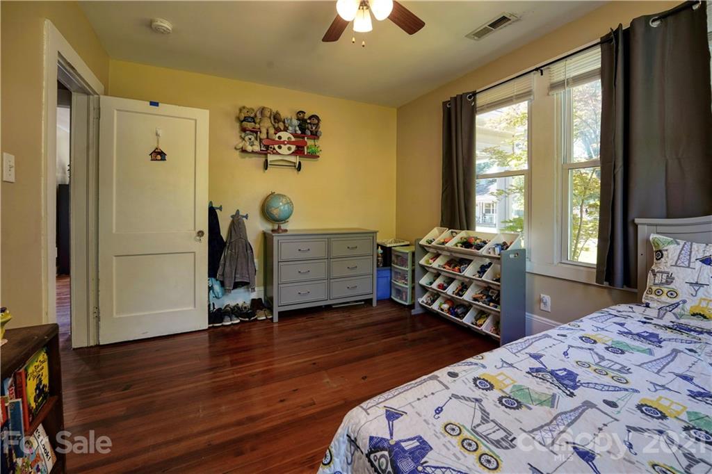 36 Bluff Avenue Southwest Concord, NC 28027 - Photo 13 of 18 a bedroom with bed and a chandelier