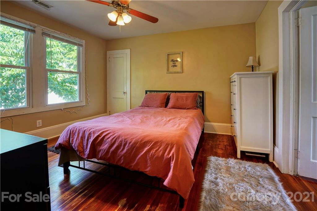 36 Bluff Avenue Southwest Concord, NC 28027 - Photo 14 of 18 a bedroom with a bed and a chandelier