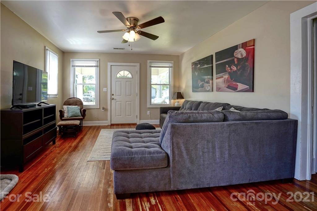 36 Bluff Avenue Southwest Concord, NC 28027 - Photo 5 of 18 a living room with furniture and a flat screen tv