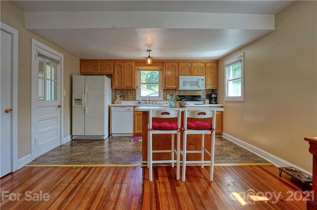 36 Bluff Avenue Southwest Concord, NC 28027 - Photo 8 of 18 a kitchen with wooden floors and refrigerator