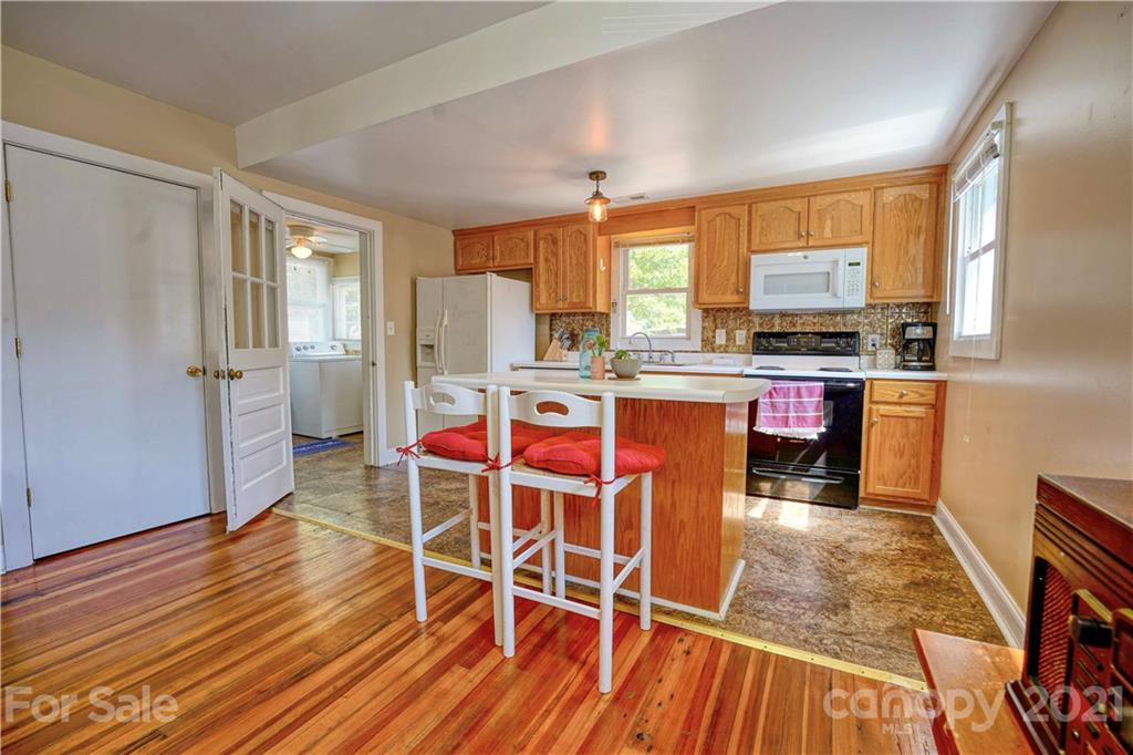 36 Bluff Avenue Southwest Concord, NC 28027 - Photo 9 of 18 a view of a kitchen with wooden floor and furniture