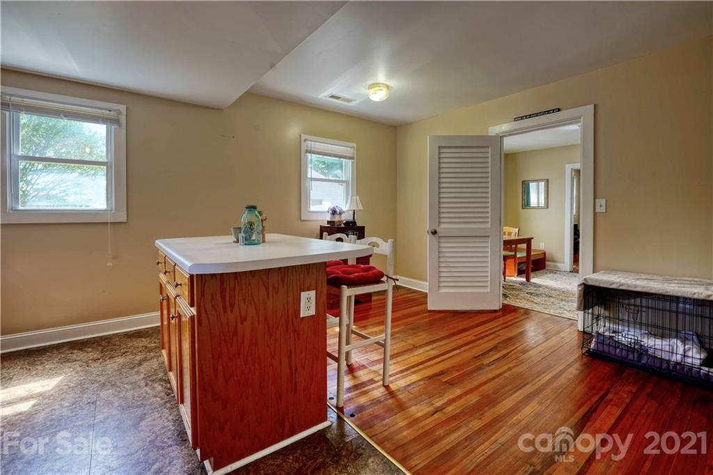 36 Bluff Avenue Southwest Concord, NC 28027 - Photo 10 of 18 a room with wooden floor and furniture