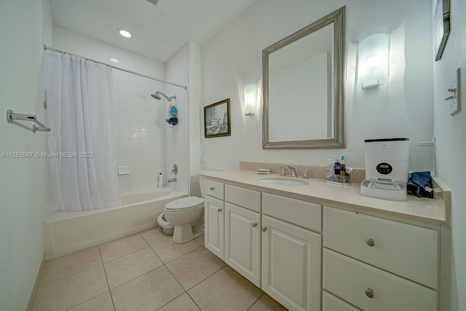 2001 Biscayne Boulevard, Unit 3401 Miami, FL 33137 - Photo 16 of 23 a bathroom with a double vanity sink toilet and shower