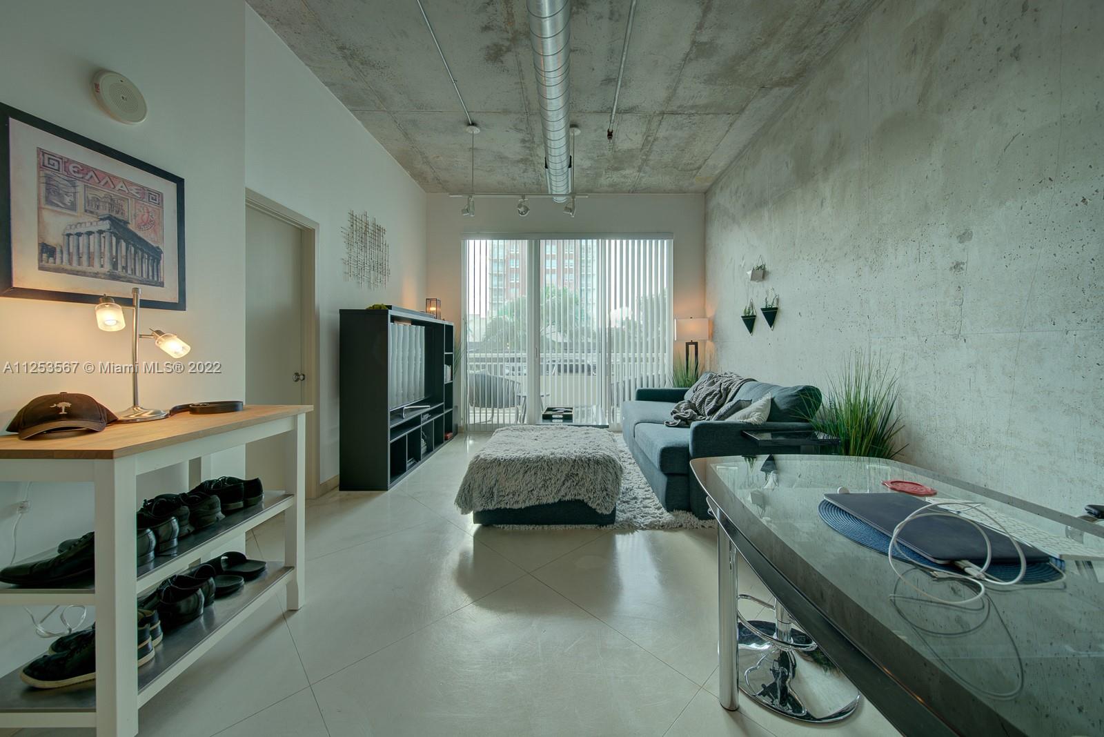 2001 Biscayne Boulevard, Unit 3401 Miami, FL 33137 - Photo 3 of 23 a large kitchen with a table chairs stove and cabinets