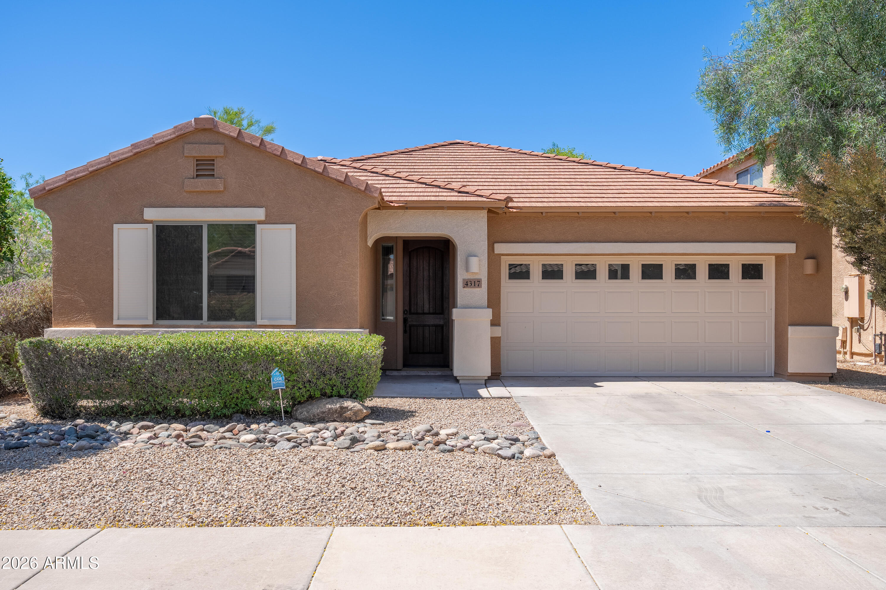4317 East Folgers Road Phoenix, AZ 85050 - Photo 1 of 40 a front view of a house with a yard and garage