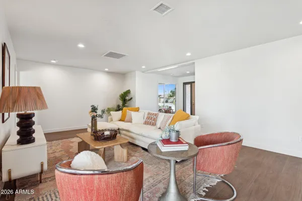 a living room with furniture and a potted plant