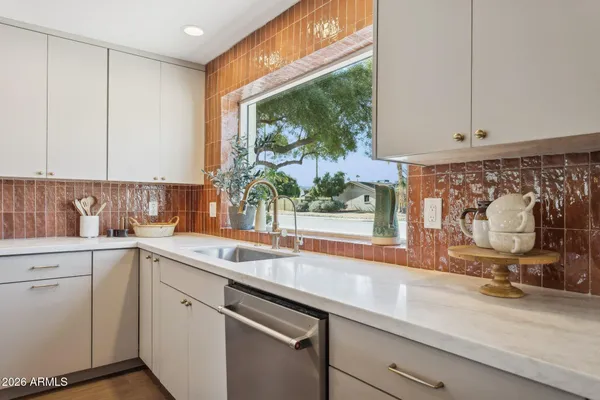 a kitchen with stainless steel appliances a refrigerator sink and cabinets