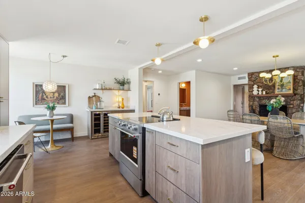 a view of kitchen with sink and refrigerator