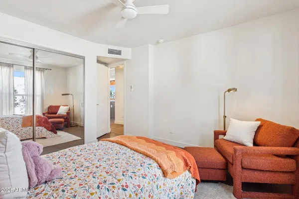 a bedroom with a bed and a mirror