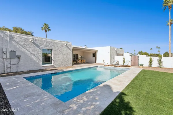 an aerial view of a house with a yard