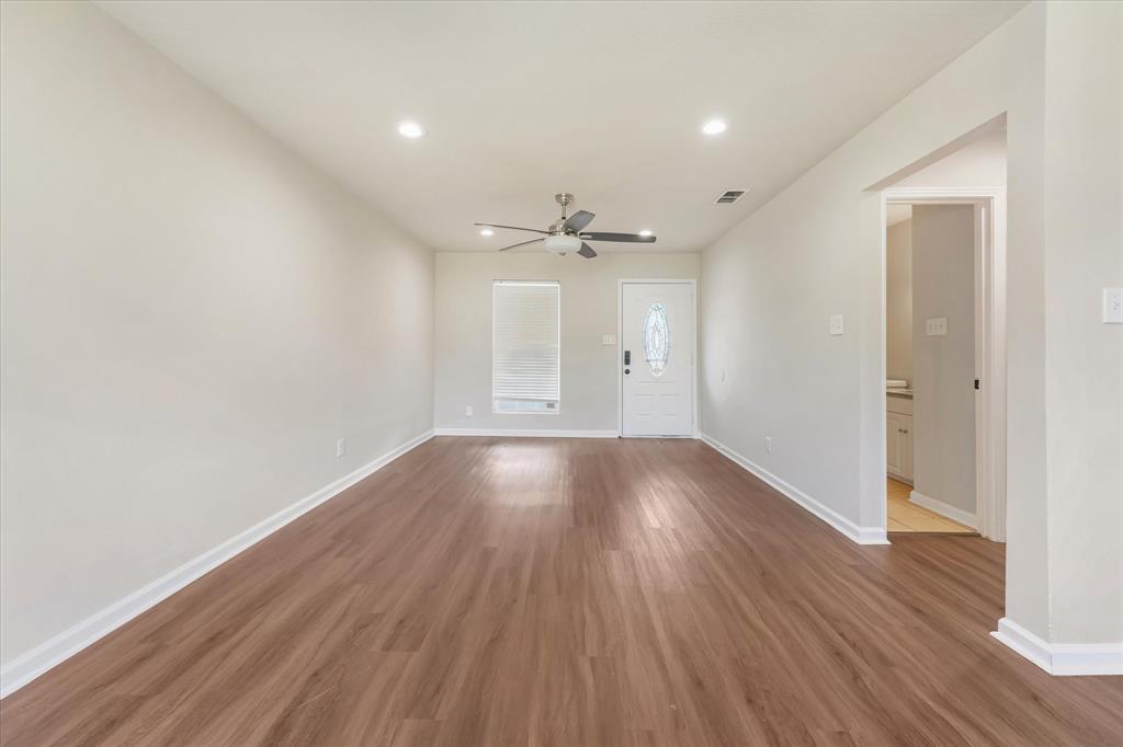 304 East Stone Road Wylie, TX 75098 - Photo 6 of 19 wooden floor in an empty room with a window