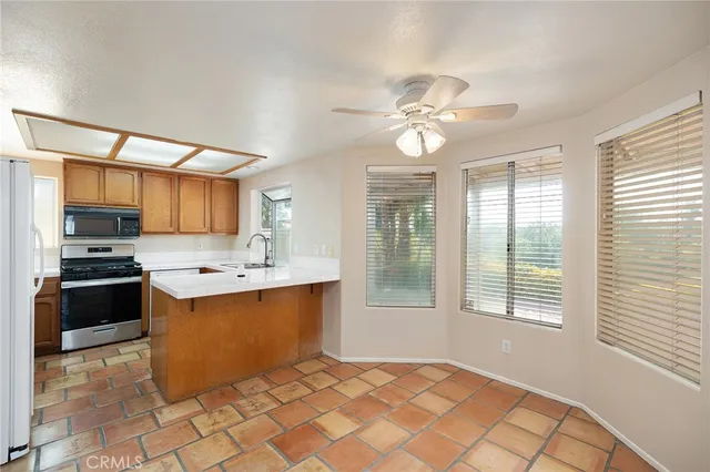 a kitchen with stainless steel appliances a sink and a window