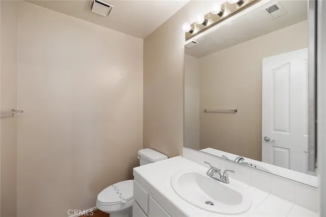 a view of an empty room and chandelier fan