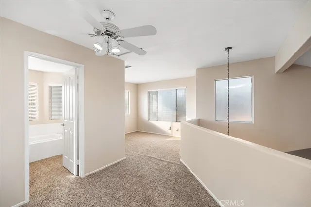 a bathroom with a bathtub sink mirror vanity and toilet