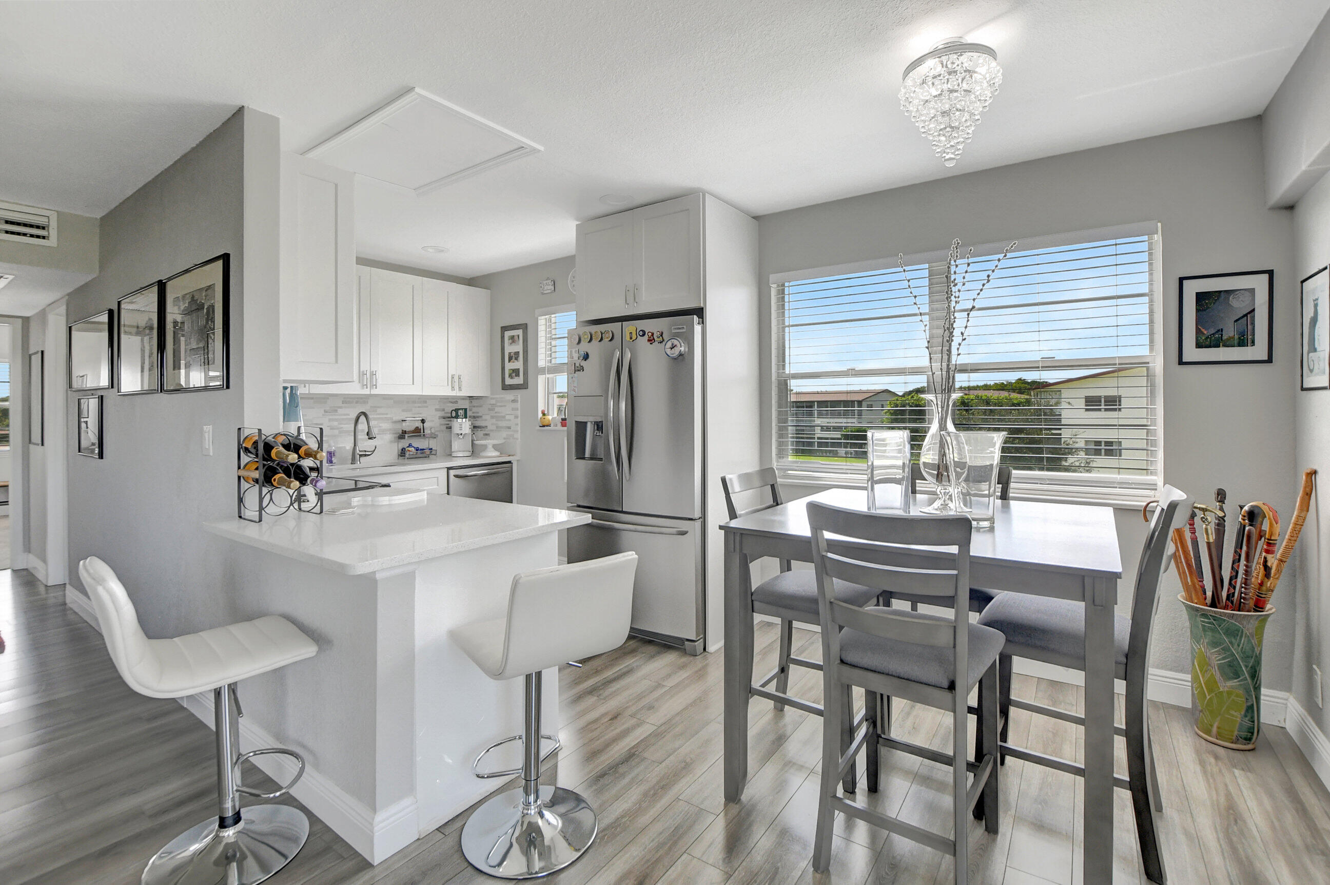 42 Brighton A Boca Raton, FL 33434 - Photo 1 of 24 a kitchen with stainless steel appliances kitchen island granite countertop a dining table chairs and a refrigerator