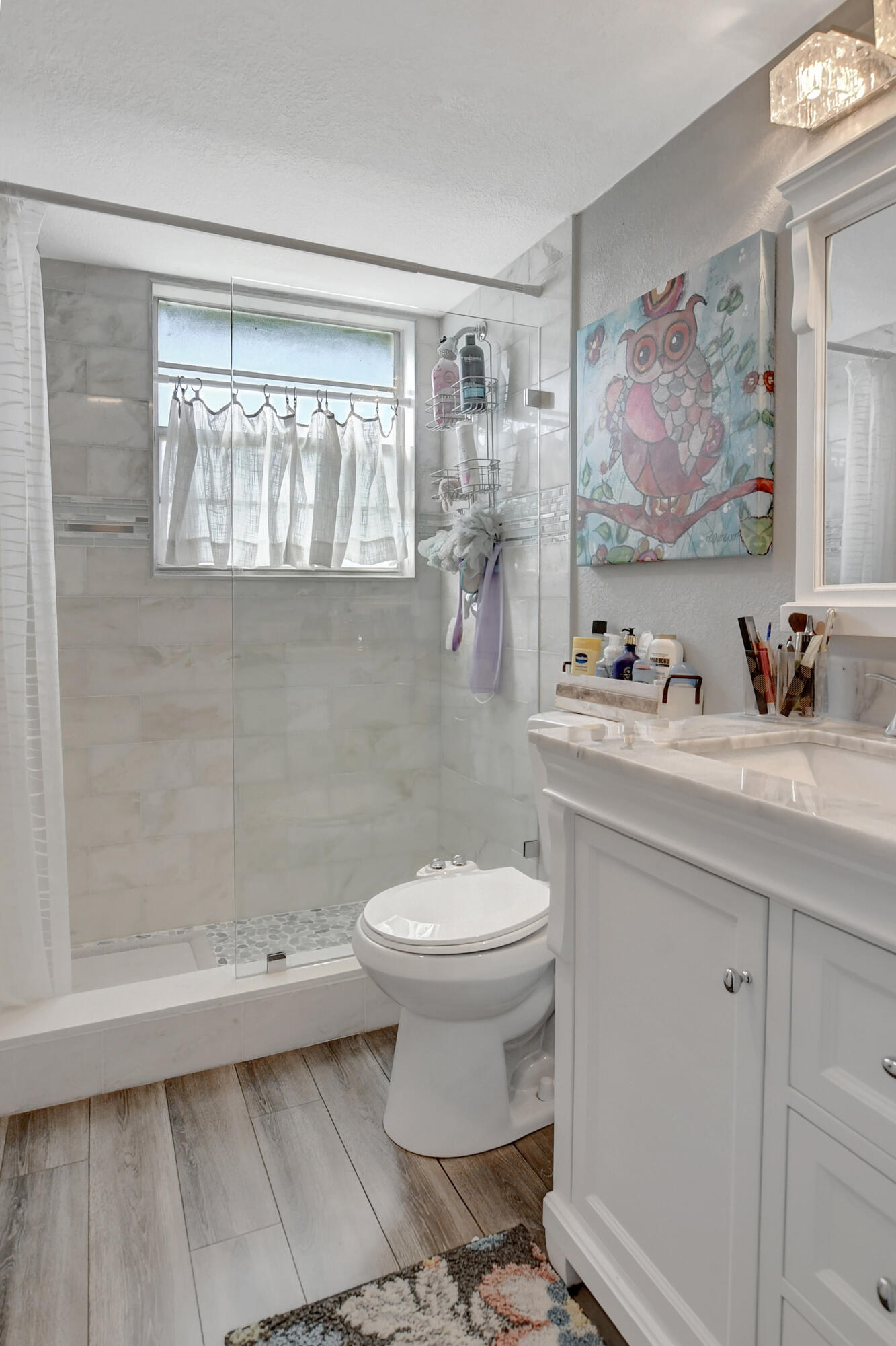 42 Brighton A Boca Raton, FL 33434 - Photo 11 of 24 a bathroom with a sink a toilet and a shower