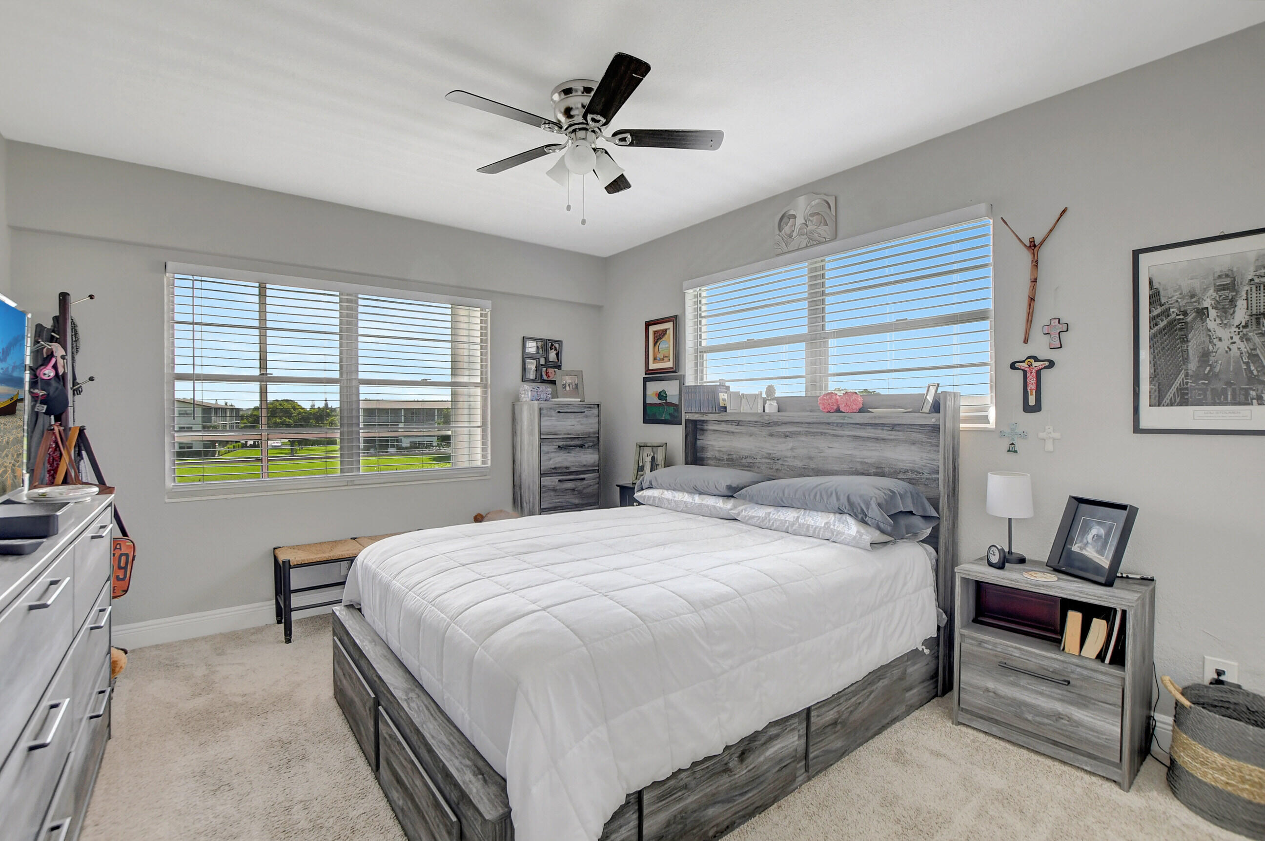 42 Brighton A Boca Raton, FL 33434 - Photo 12 of 24 a spacious bedroom with a bed a table and a large window