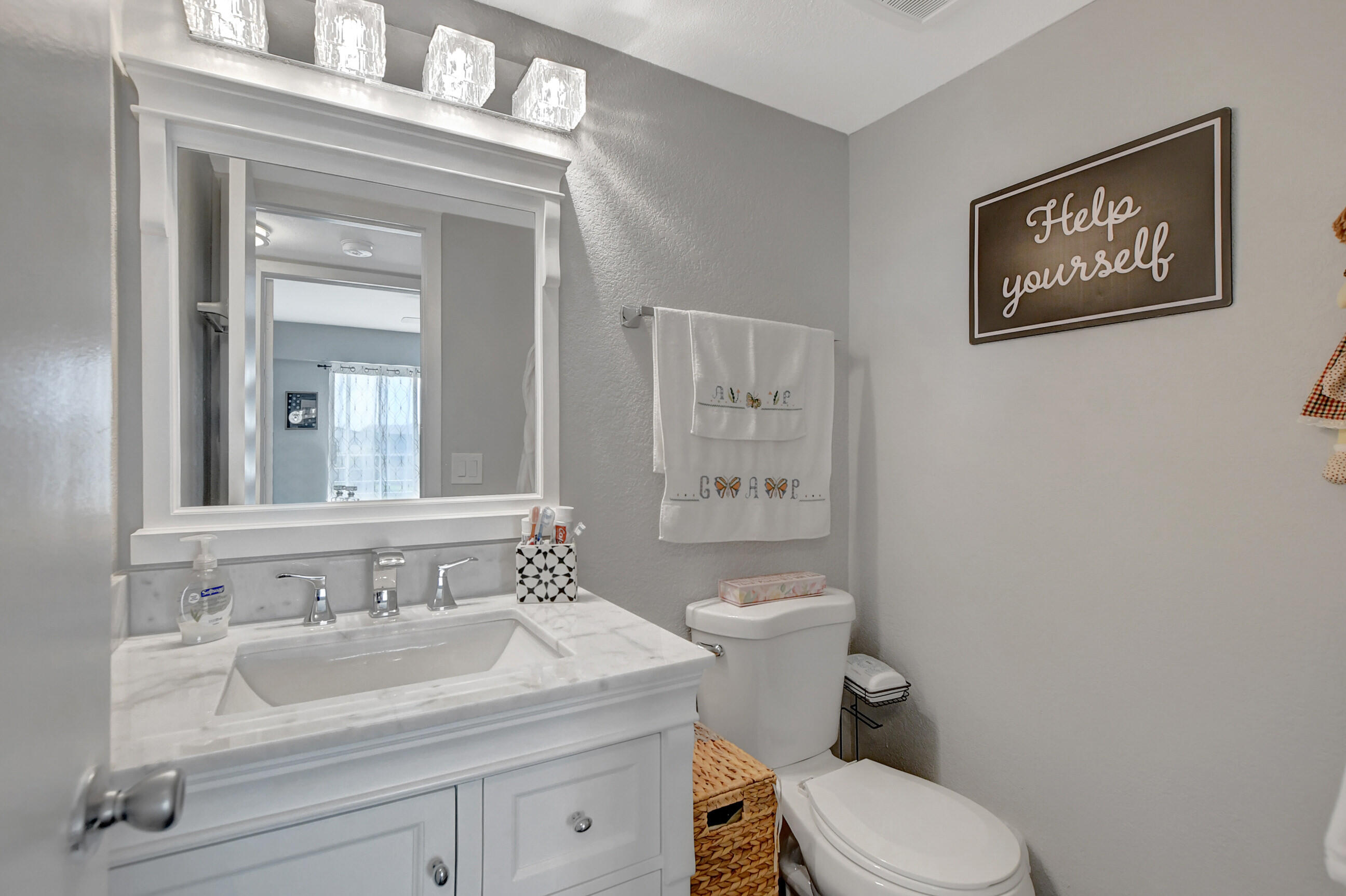 42 Brighton A Boca Raton, FL 33434 - Photo 14 of 24 a bathroom with a toilet sink and mirror