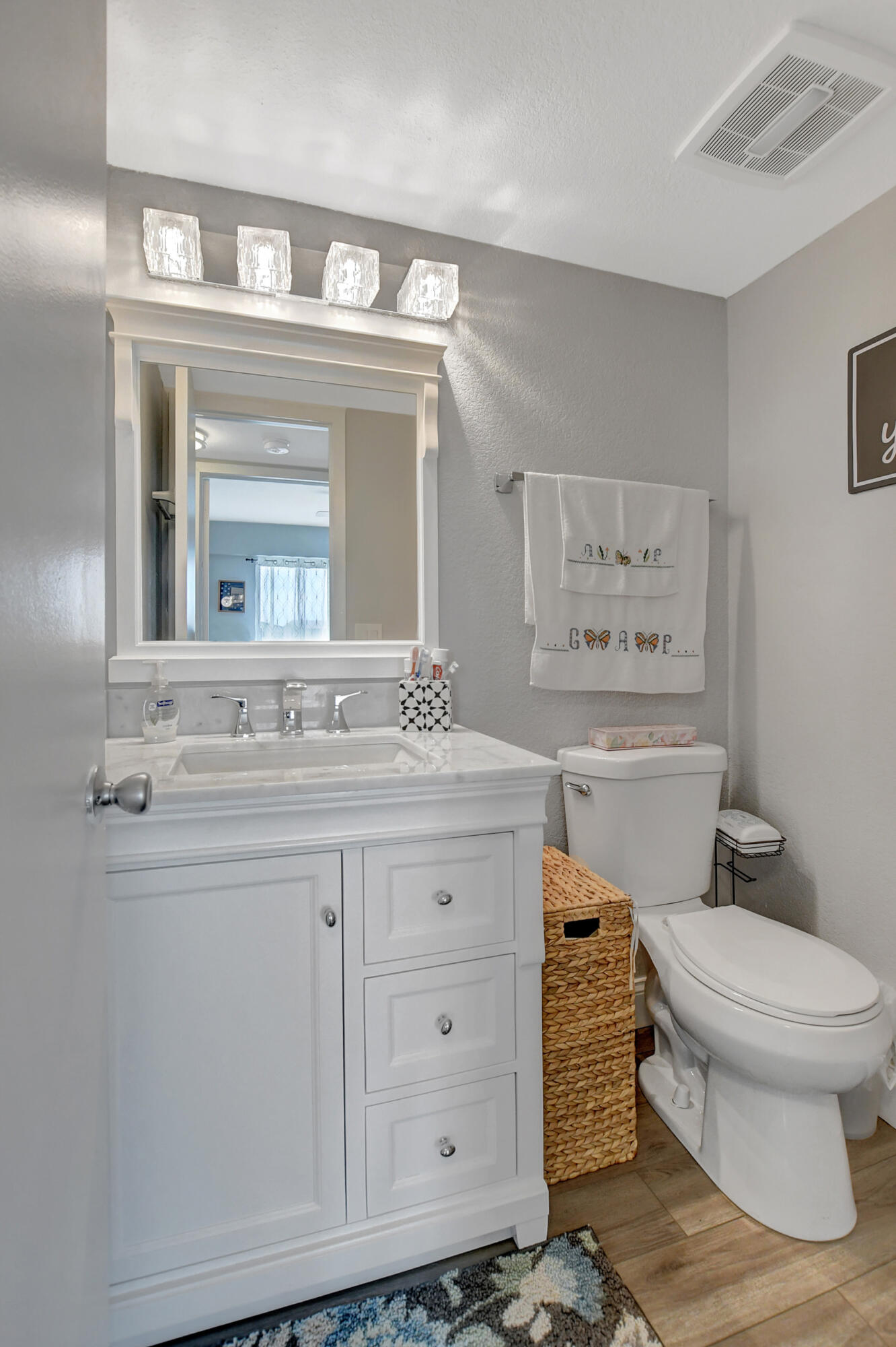 42 Brighton A Boca Raton, FL 33434 - Photo 15 of 24 a bathroom with a granite countertop toilet sink and mirror