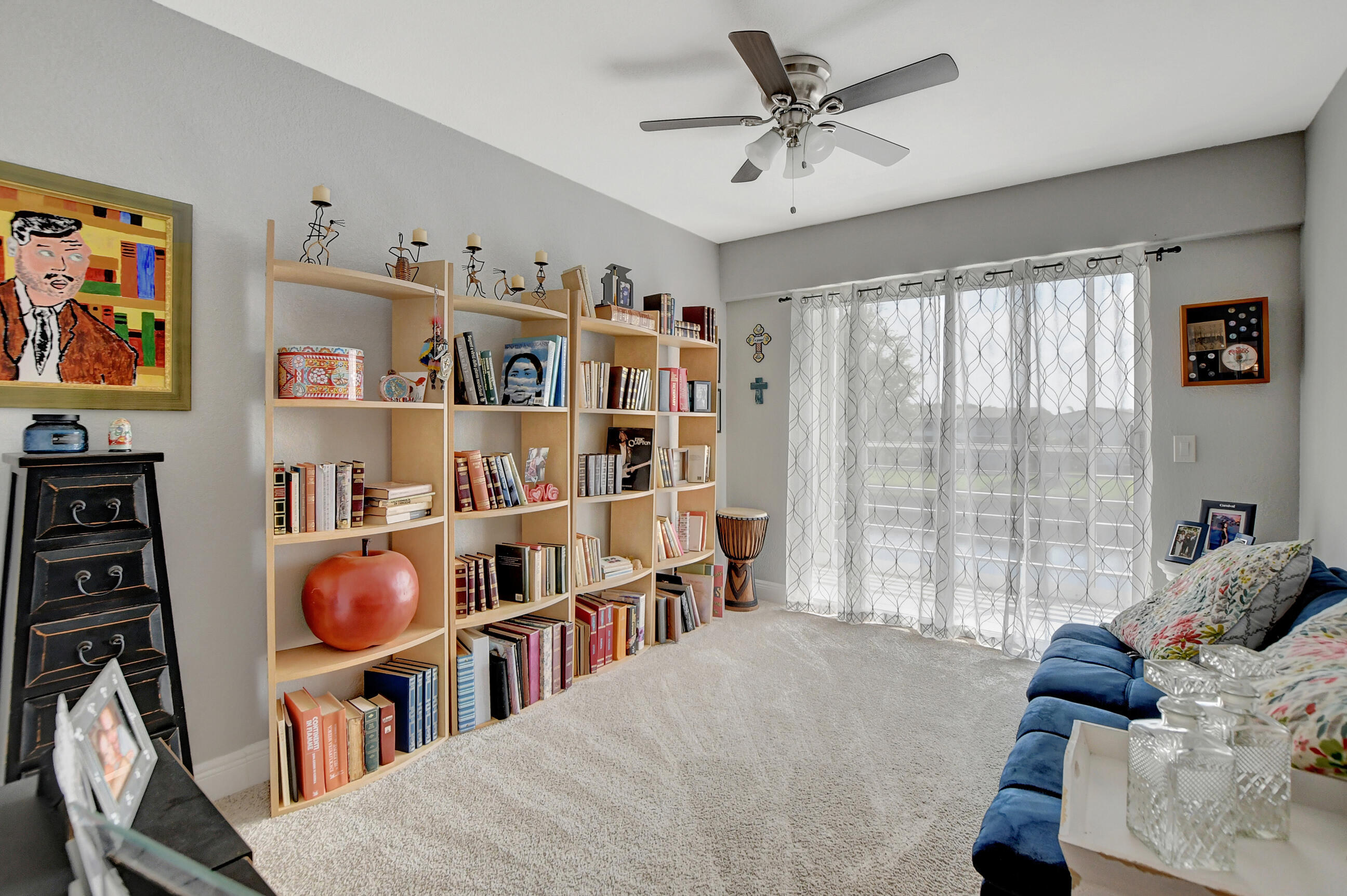 42 Brighton A Boca Raton, FL 33434 - Photo 16 of 24 a living room with lots of furniture and a book shelf
