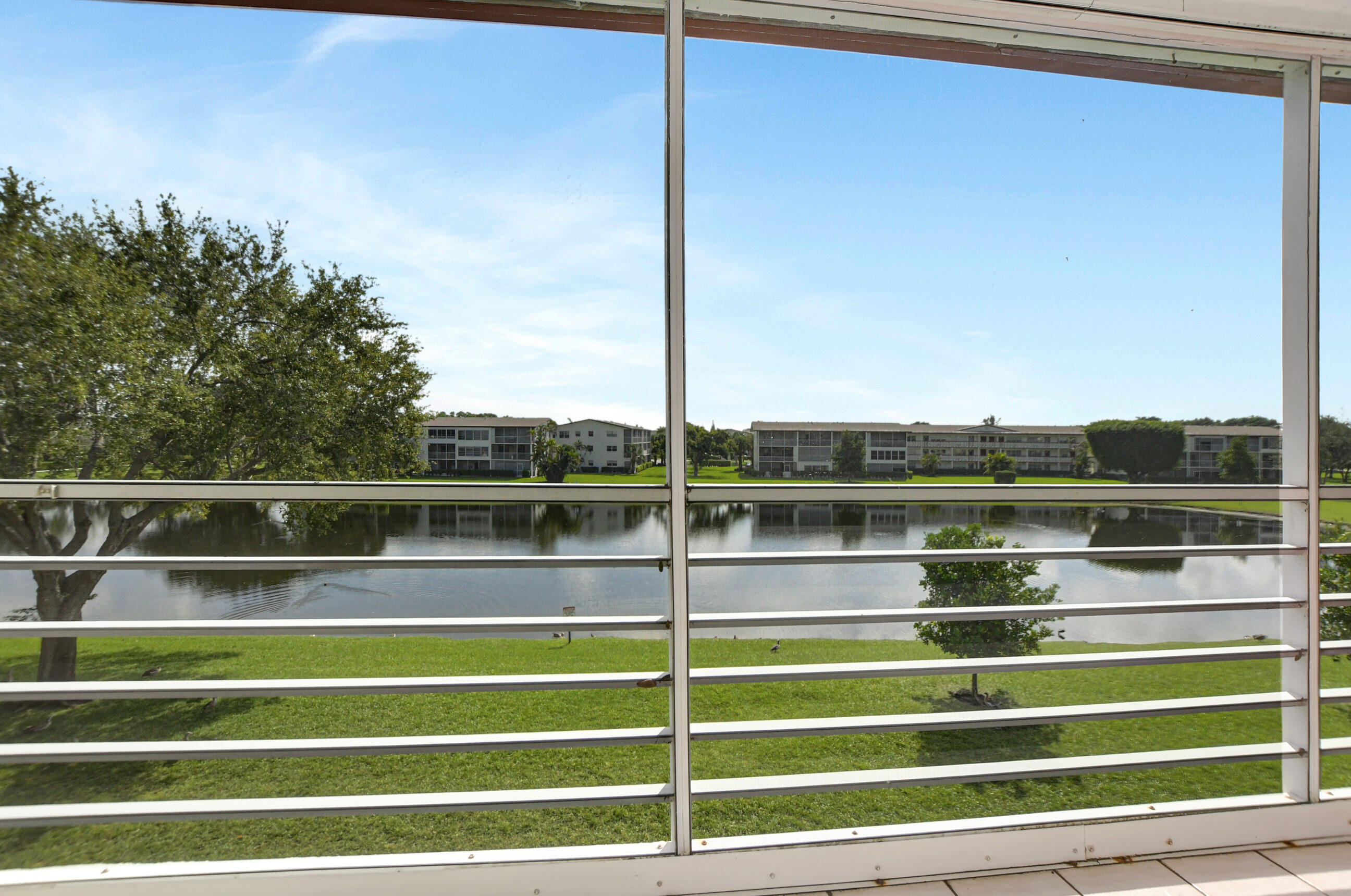 42 Brighton A Boca Raton, FL 33434 - Photo 18 of 24 a view of a balcony with floor to ceiling windows and wooden floor