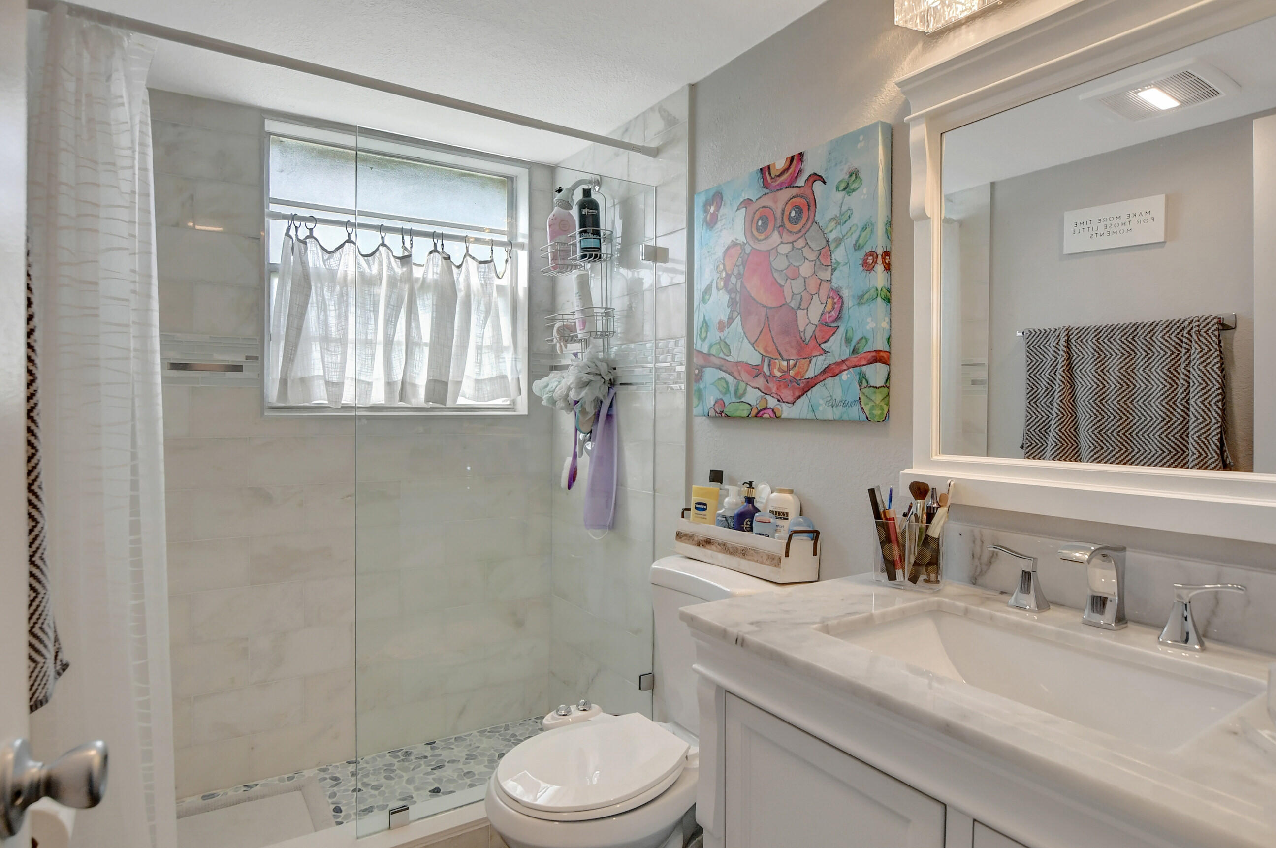 42 Brighton A Boca Raton, FL 33434 - Photo 10 of 24 a bathroom with a granite countertop sink a toilet and a shower curtain