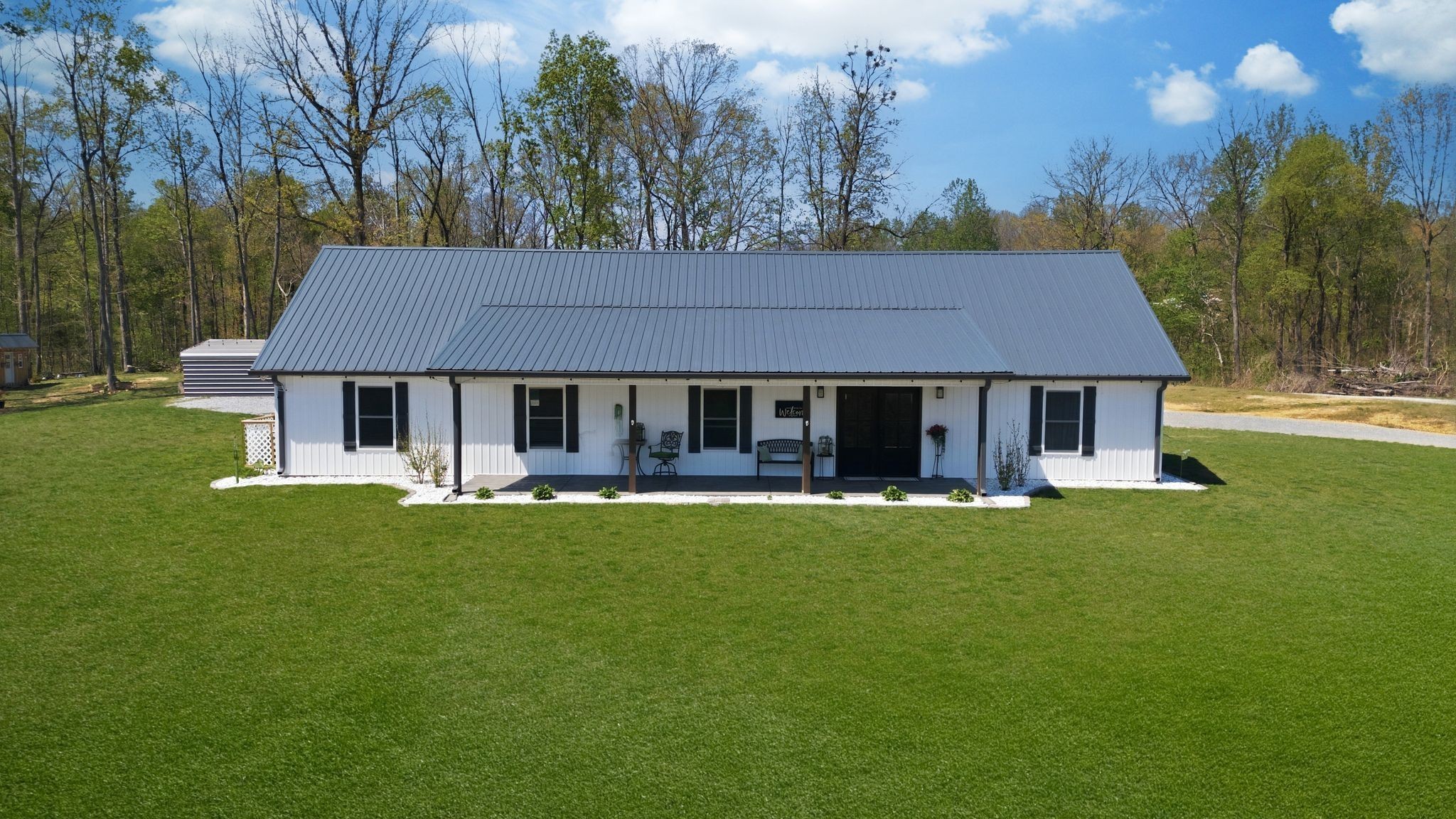 1043 Murphy Hollow Road Vanleer, TN 37181 - Photo 40 of 68 a front view of a house with a garden and porch