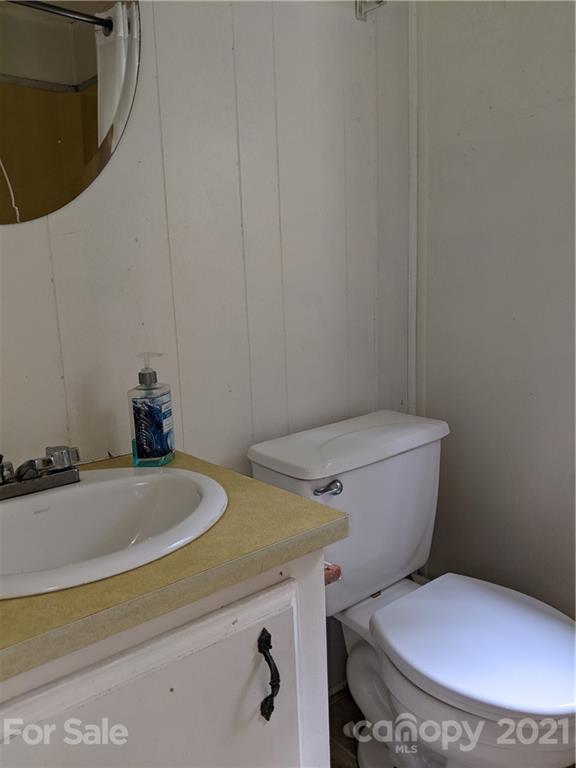 204 Water Filter Plant Road Morganton, NC 28655 - Photo 11 of 13 a white toilet sitting next to a bathroom sink