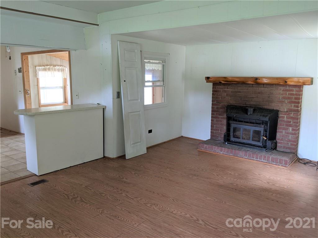 204 Water Filter Plant Road Morganton, NC 28655 - Photo 5 of 13 an empty room with windows and fireplace