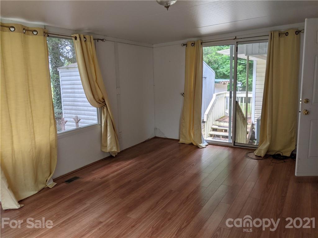 204 Water Filter Plant Road Morganton, NC 28655 - Photo 8 of 13 an empty room with wooden floor and windows