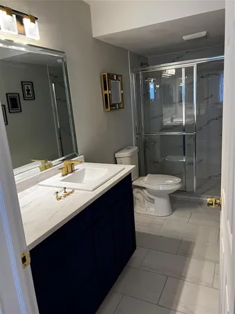 a bathroom with a toilet mirror and shower