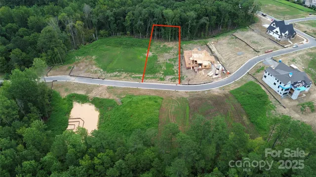 an aerial view of a house with a yard basket ball court and outdoor seating