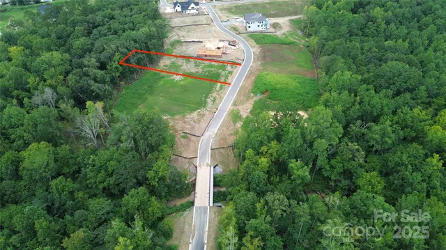 an aerial view of residential house with outdoor space and trees around