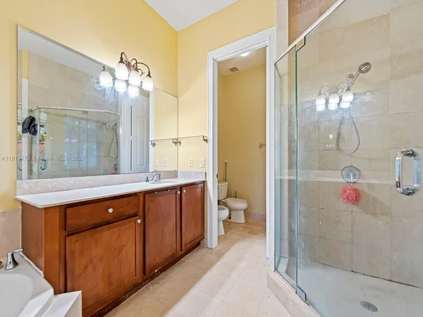 a bathroom with a sink a toilet and shower