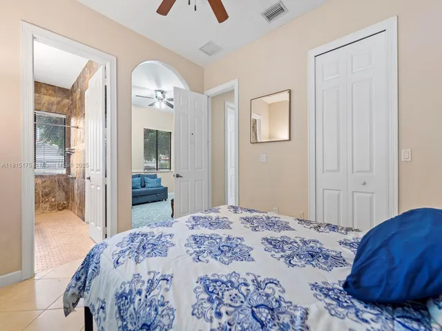 a bedroom with a bed and a mirror