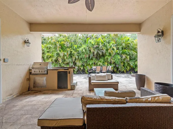 a view of a patio with table and chairs